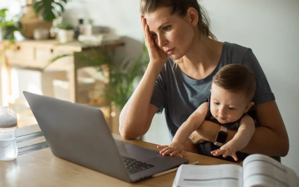 Woman with baby in front of laptop