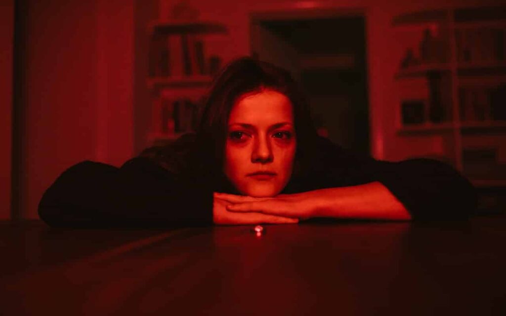 Unhappy woman in red light